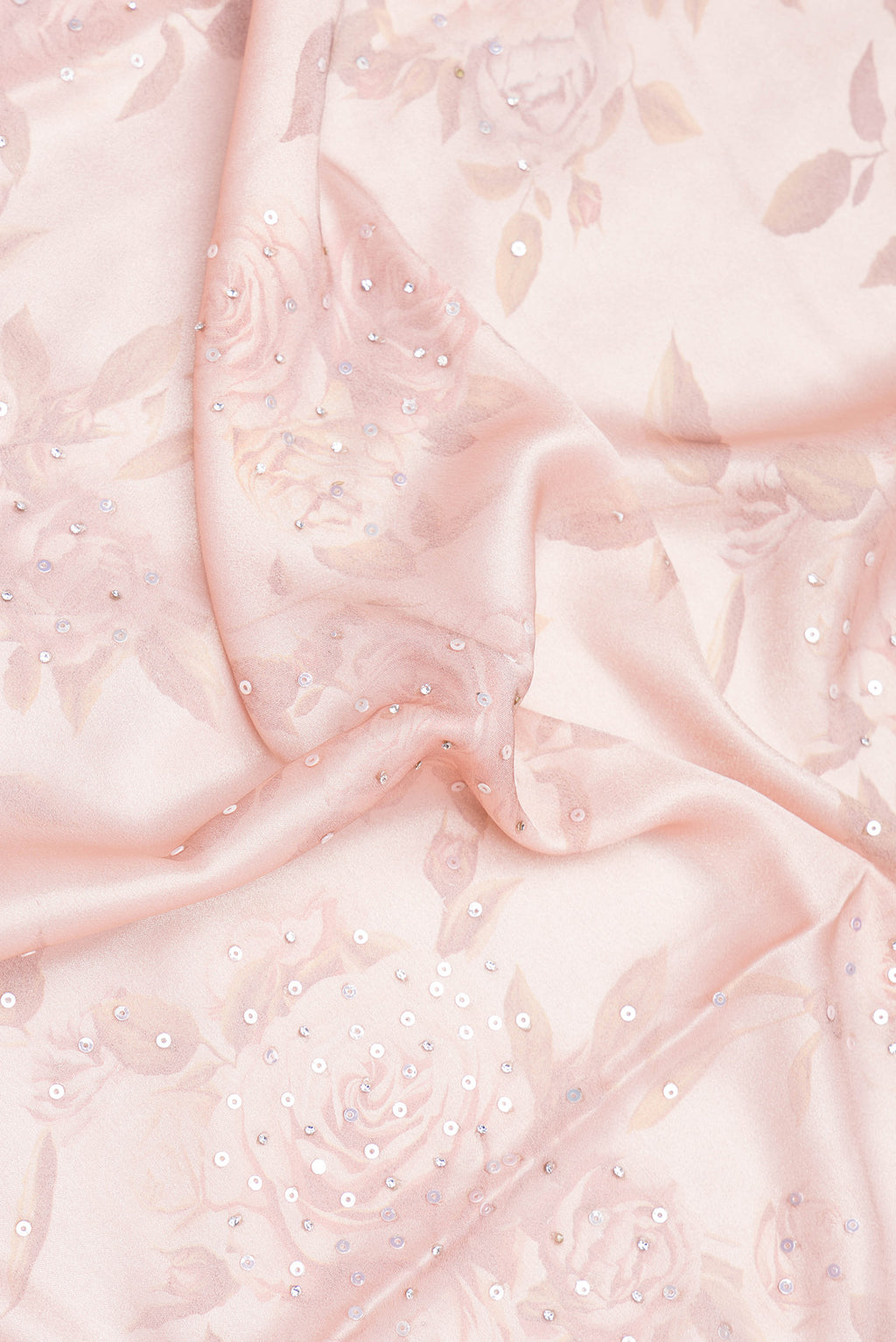Close up of Rose Gold Dual Tone Georgette Saree with Embroidery on the body and Embroidery Border.  displaying folds