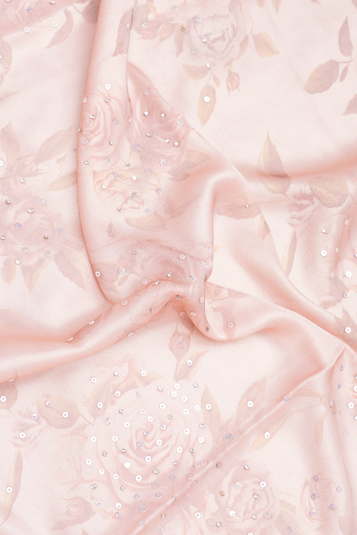 Close up of Rose Gold Dual Tone Georgette Saree with Embroidery on the body and Embroidery Border.  displaying folds