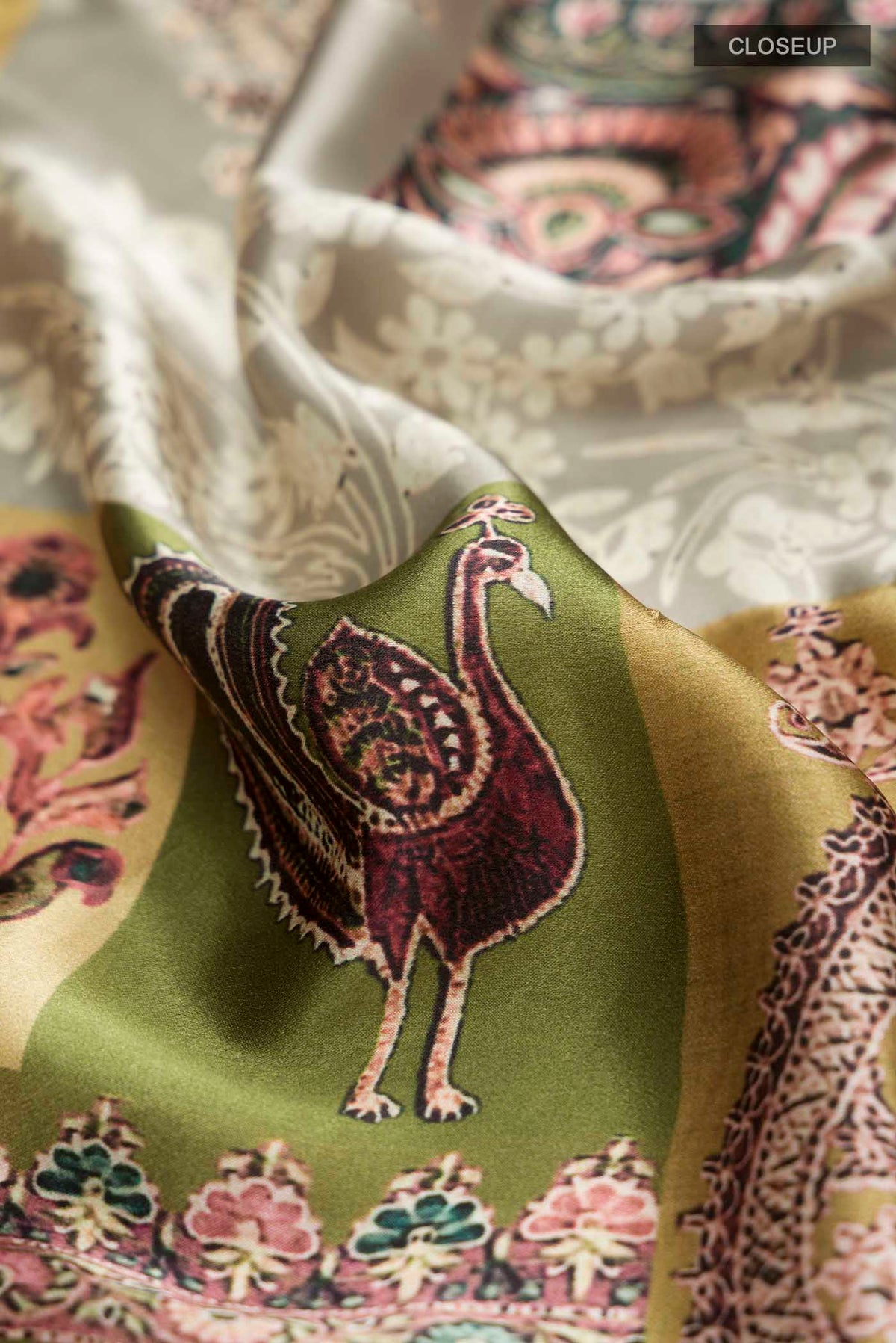 Close up of Green Satin Silk Saree with Printed design on the body and Without Border displaying folds