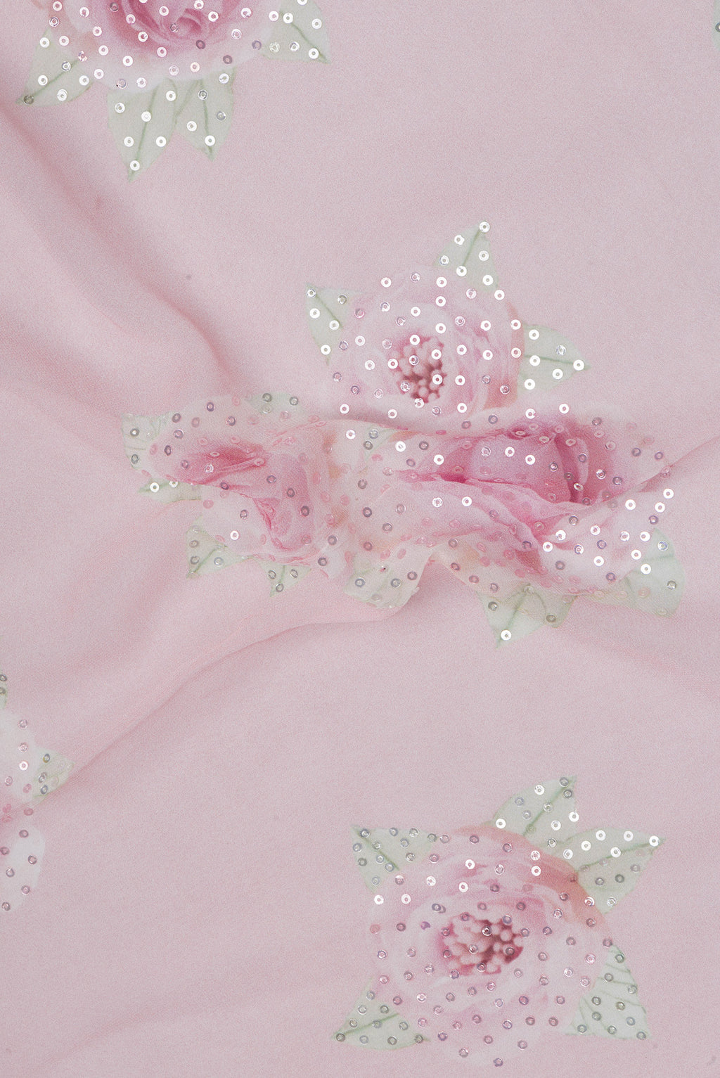 Close up of Pink Georgette Saree with Embroidery on the body and Embroidery Border.  displaying folds