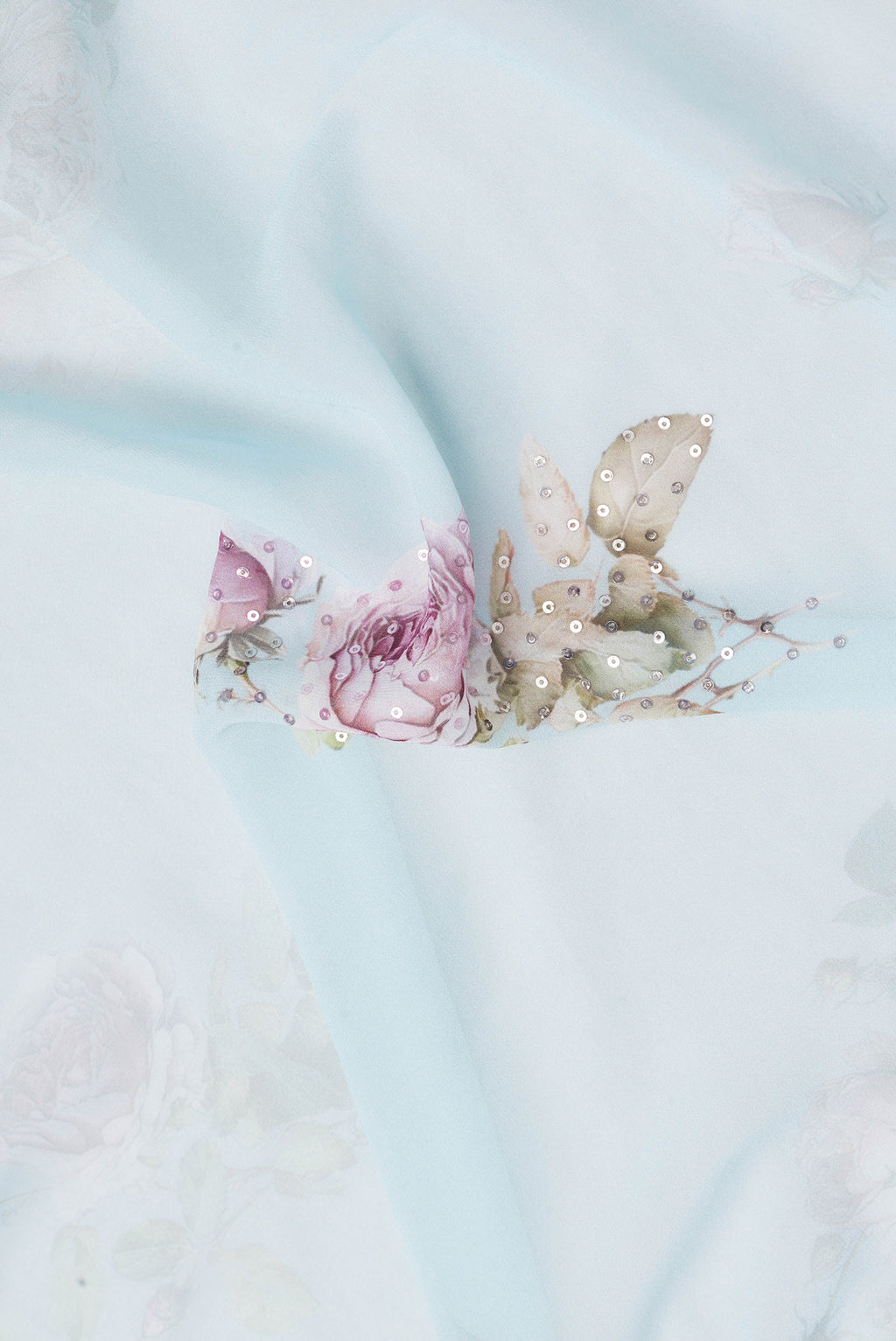 Close up of Sky Blue Dual Tone Georgette Saree with Embroidery on the body and Embroidery Border.  displaying folds
