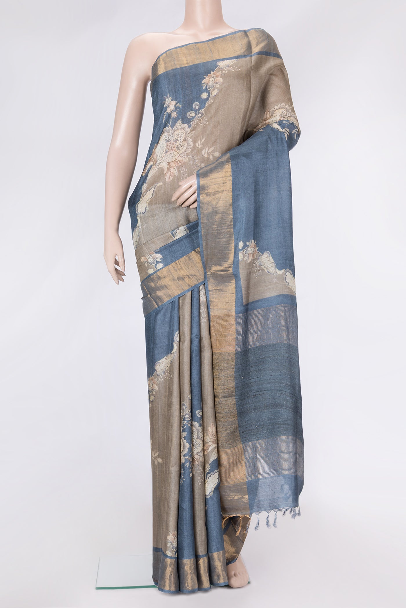 Grey Dual Tone Tussar Silk Saree with Printed design on the body and Zari Border.  displayed on a mannequin