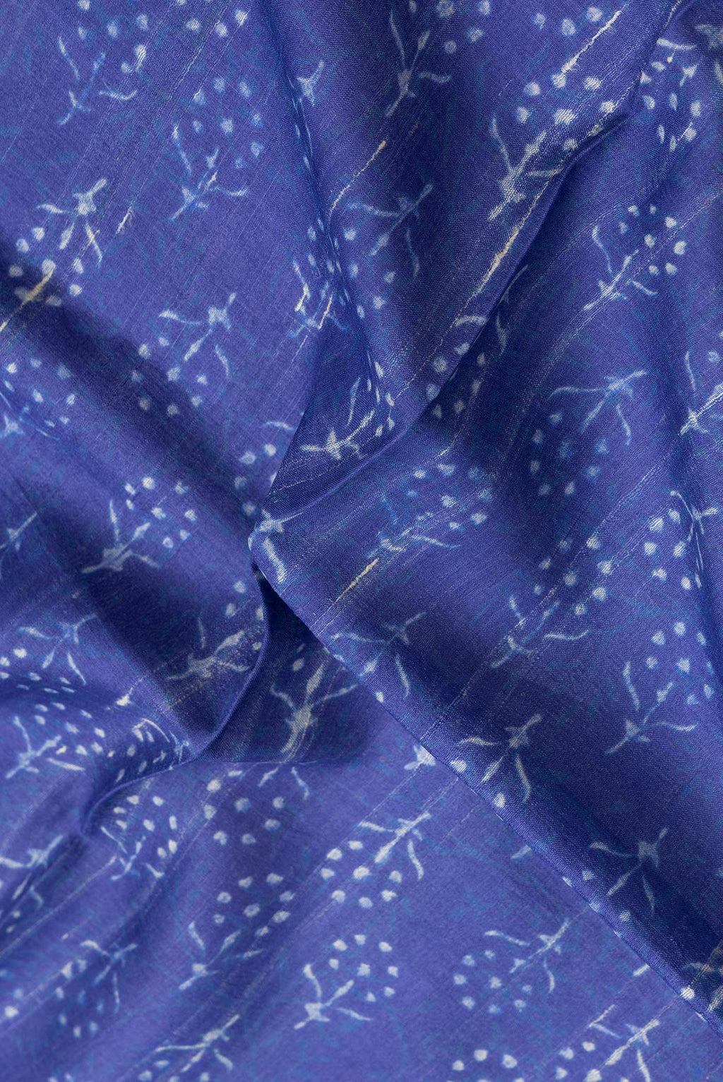 Close up of Navy Blue Dual Tone Tussar Silk Saree with Printed design on the body and Zari Border.  displaying folds