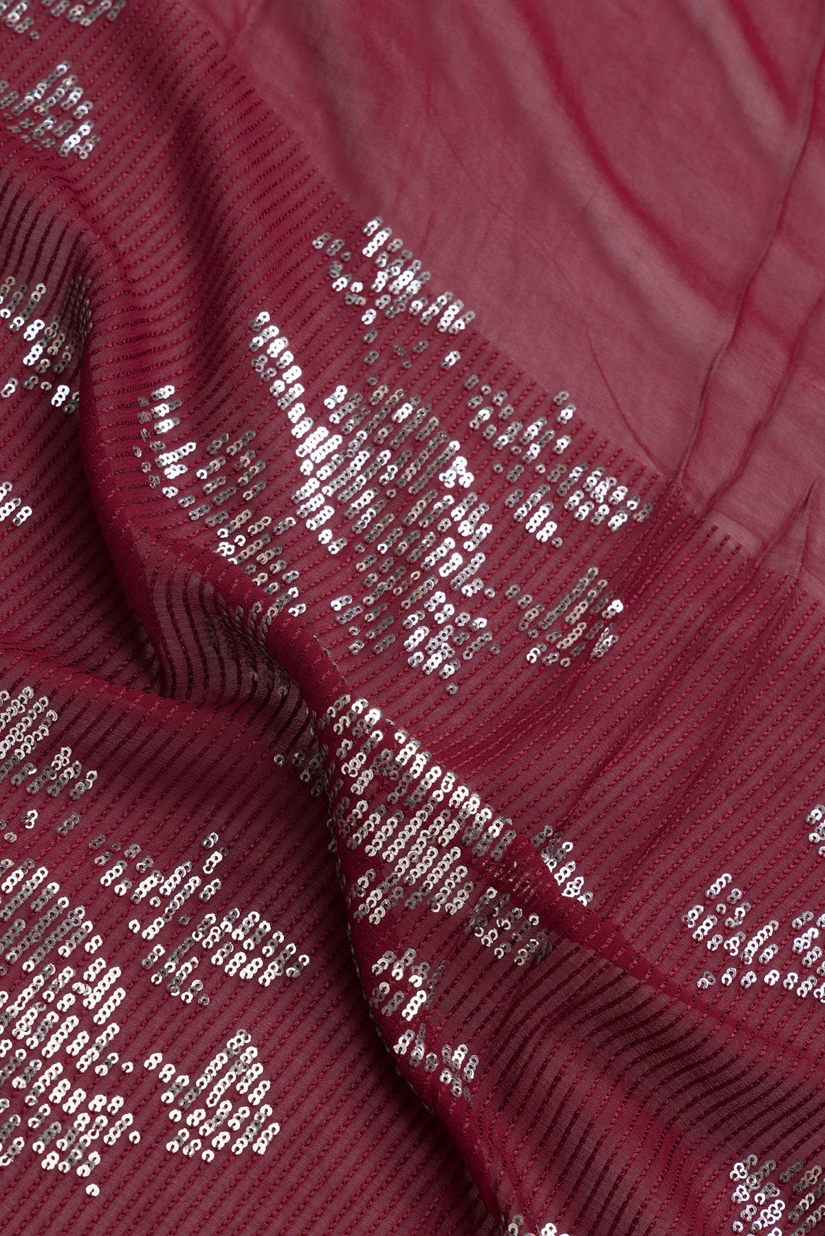 Close up of Maroon Dual Tone Mysore Georgette Saree with Embroidery on the body and Without Border.  displaying folds
