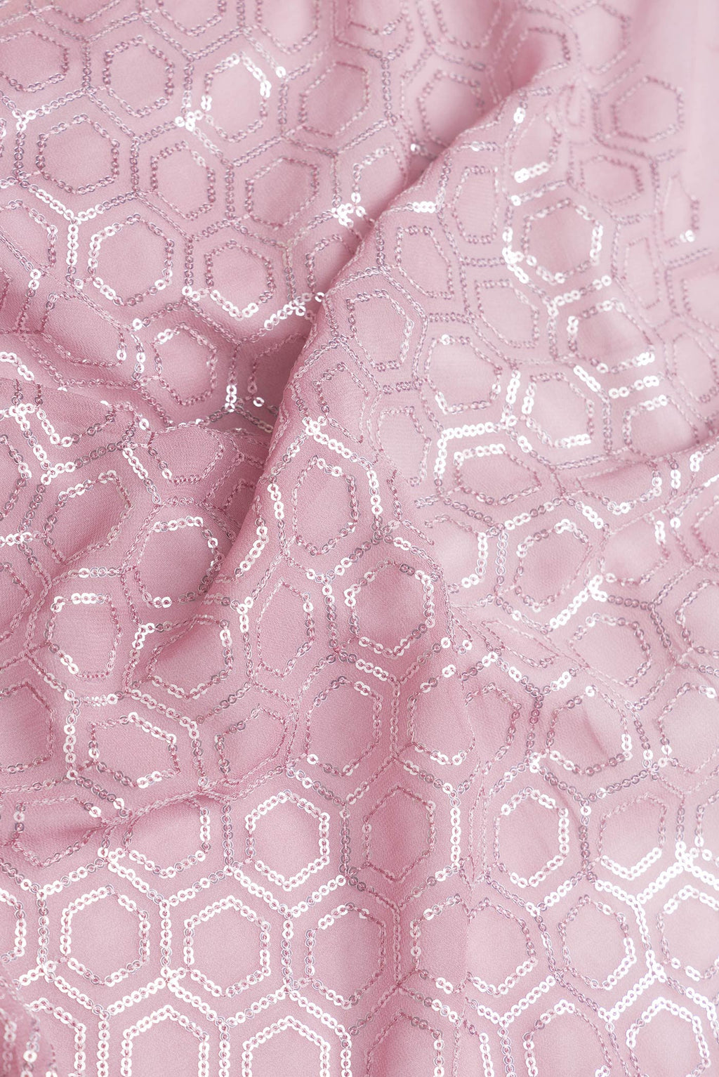 Close up of Rose Gold Dual Tone Georgette Saree with Embroidery on the body and Embroidery Border.  displaying folds