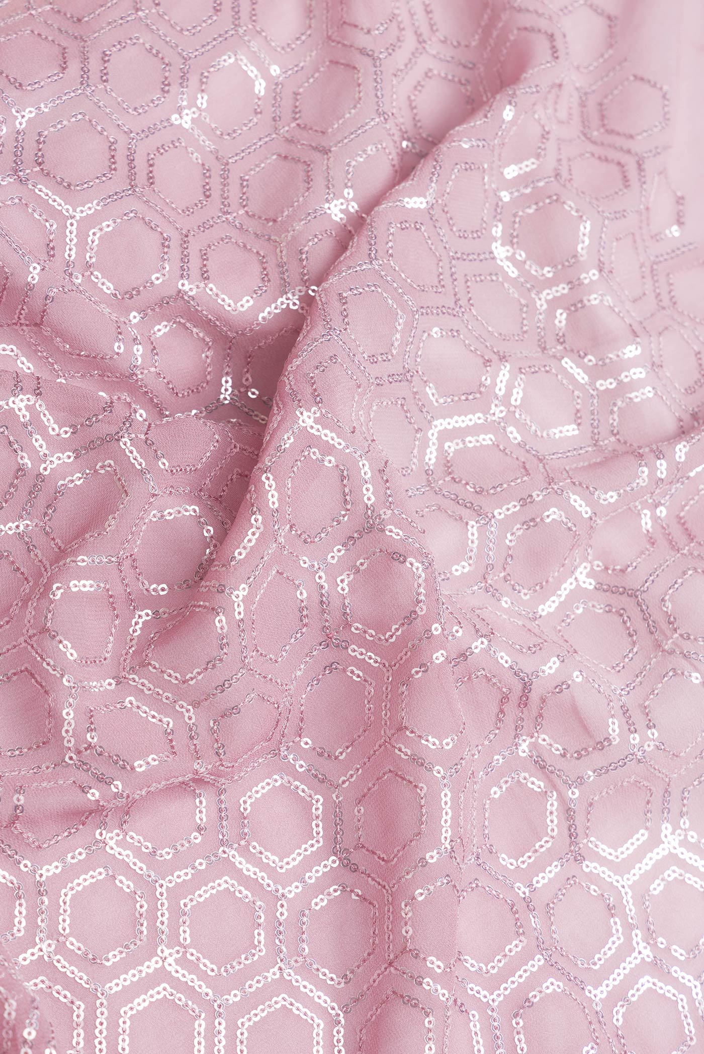 Close up of Rose Gold Dual Tone Georgette Saree with Embroidery on the body and Embroidery Border.  displaying folds