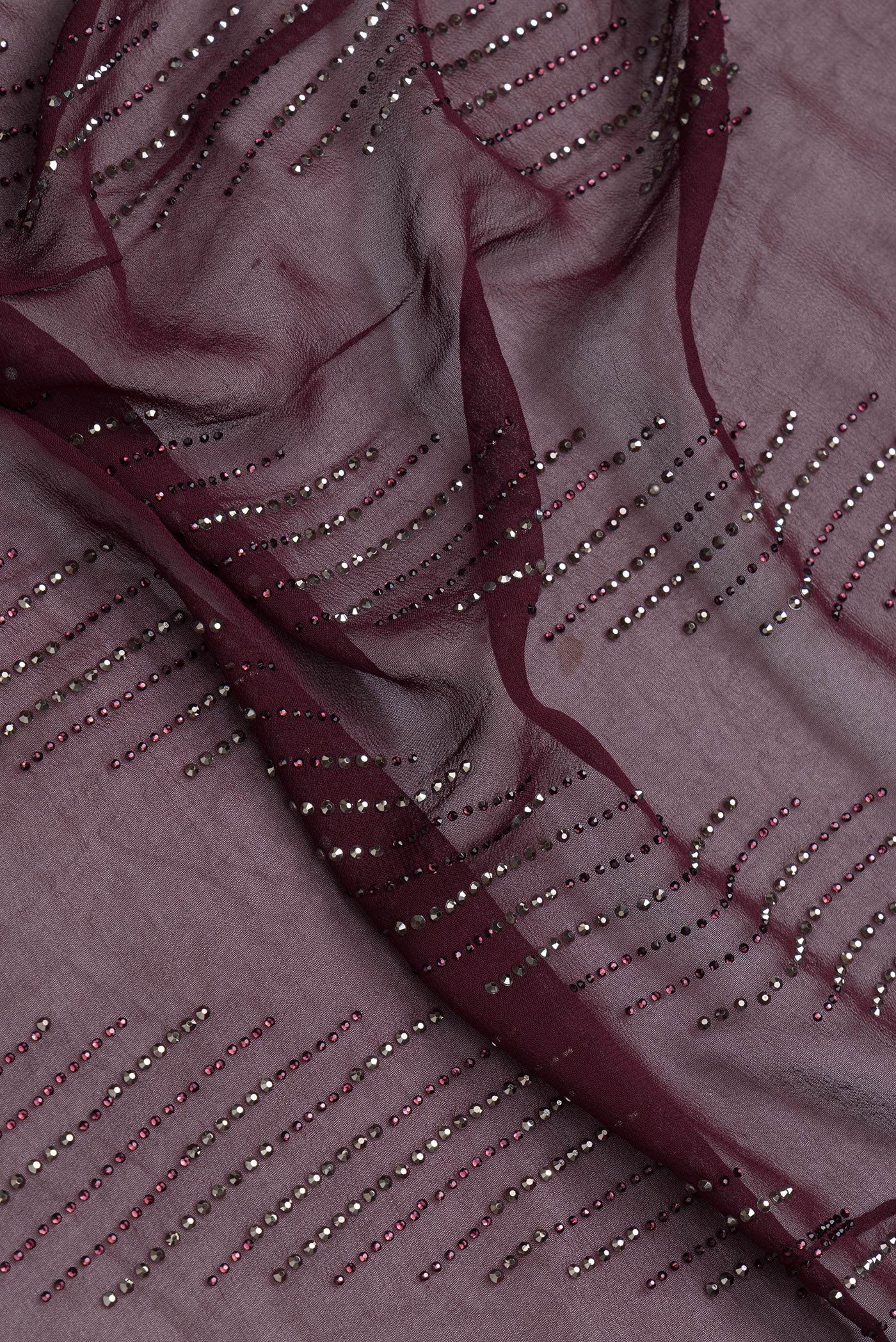 Close up of Burgundy Dual Tone Georgette Saree with Embroidery on the body and Embroidery Border.  displaying folds