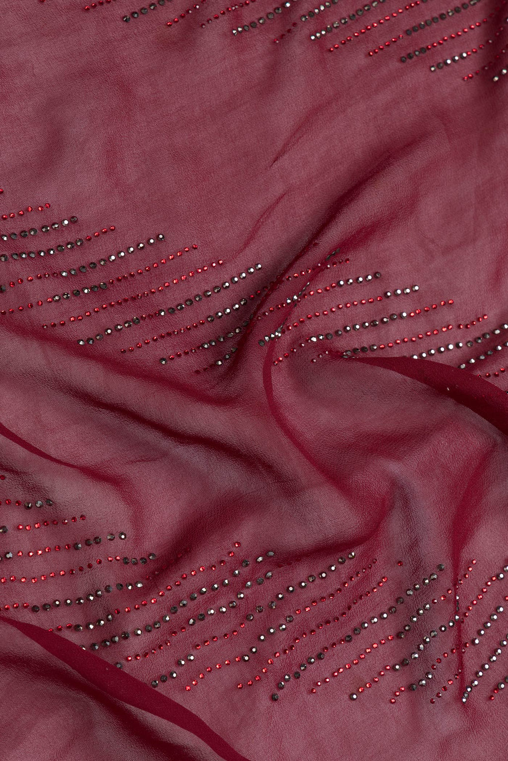 Close up of Maroon Dual Tone Georgette Saree with Embroidery on the body and Embroidery Border.  displaying folds
