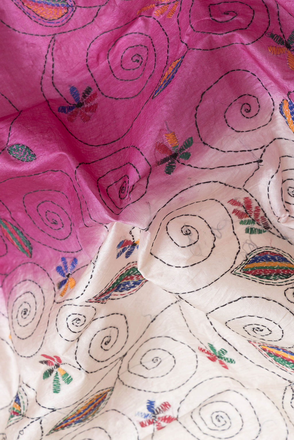 Close up of Pink Dual Tone Tussar Silk Saree with Embroidery on the body and Embroidery Border.  displaying folds
