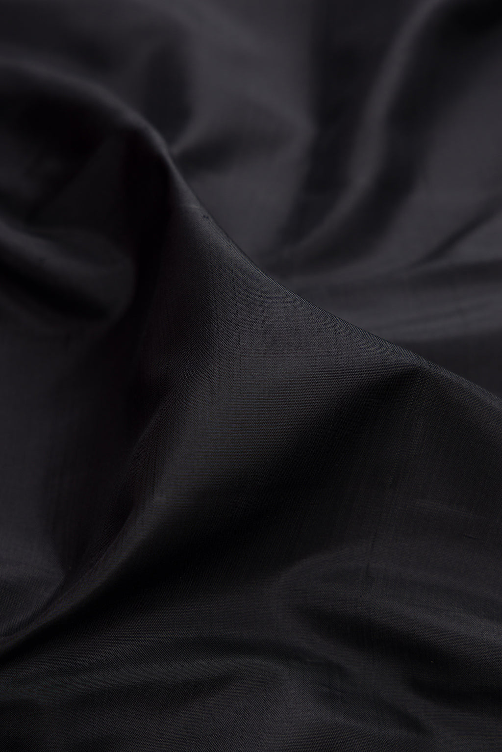 Close up of Black Kanjivaram Silk Saree with Plain Body and Temple Border.  displaying folds