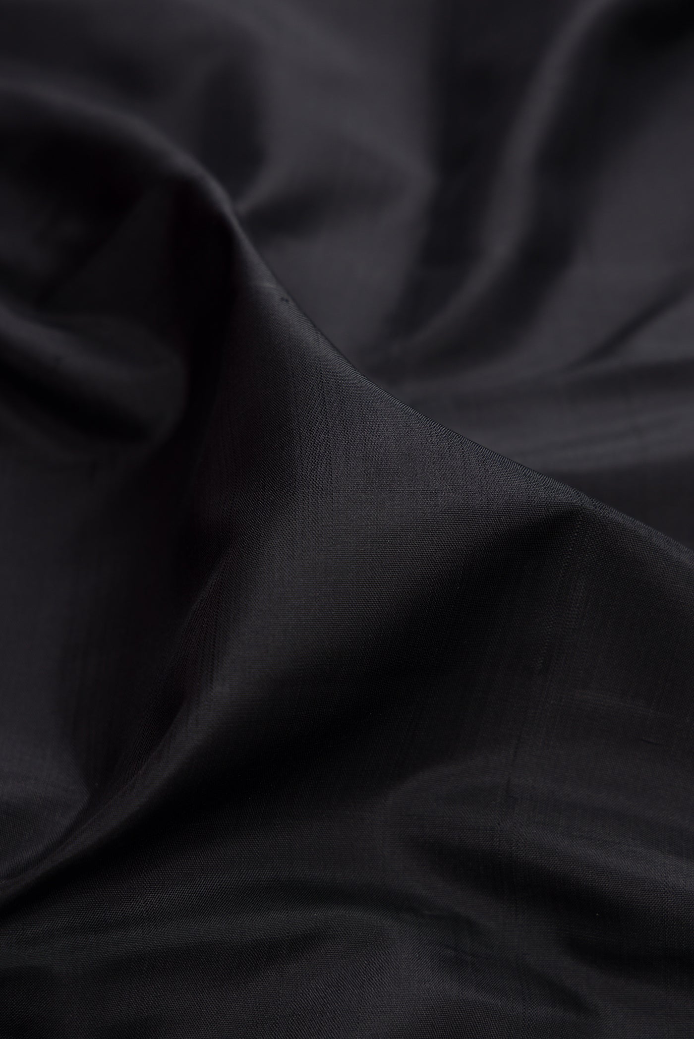 Close up of Black Kanjivaram Silk Saree with Plain Body and Temple Border.  displaying folds
