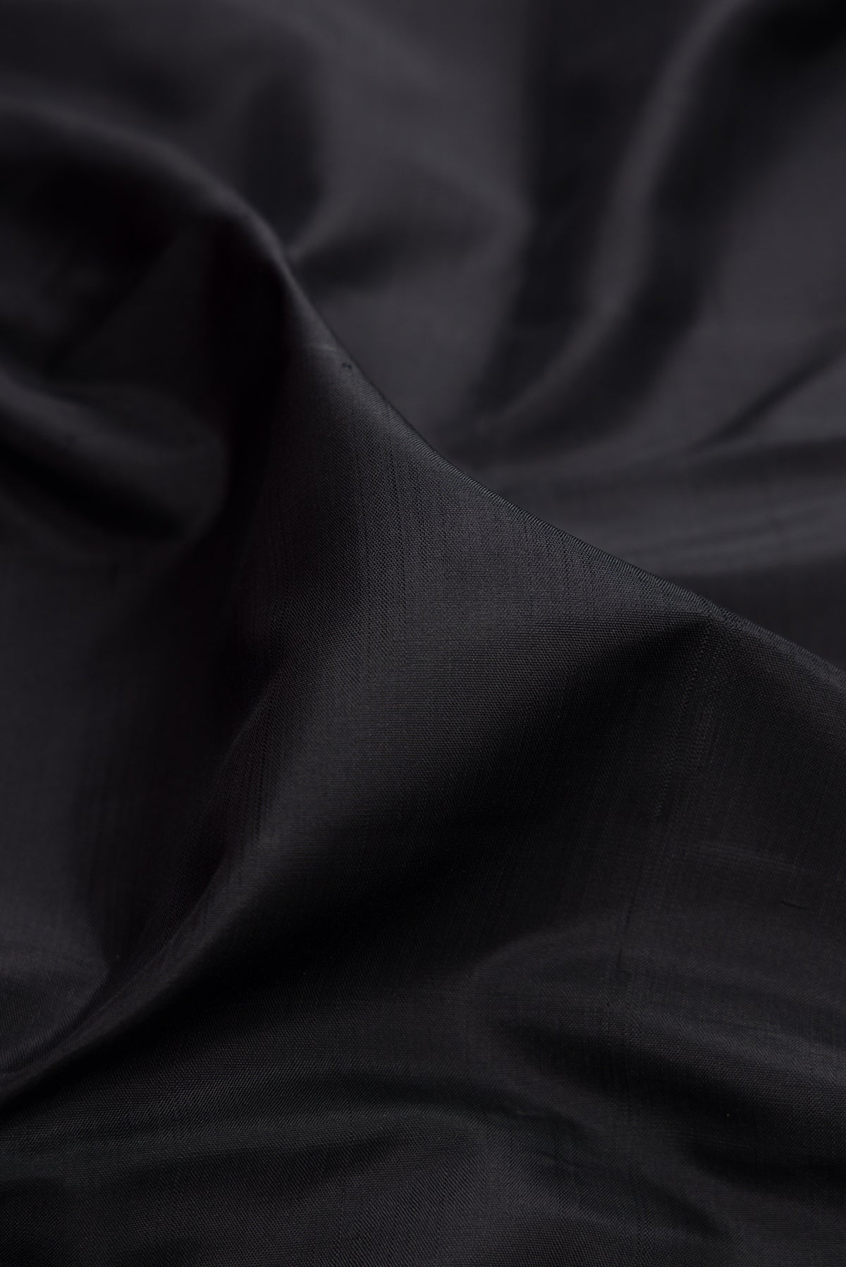 Close up of Black Kanjivaram Silk Saree with Plain Body and Temple Border.  displaying folds