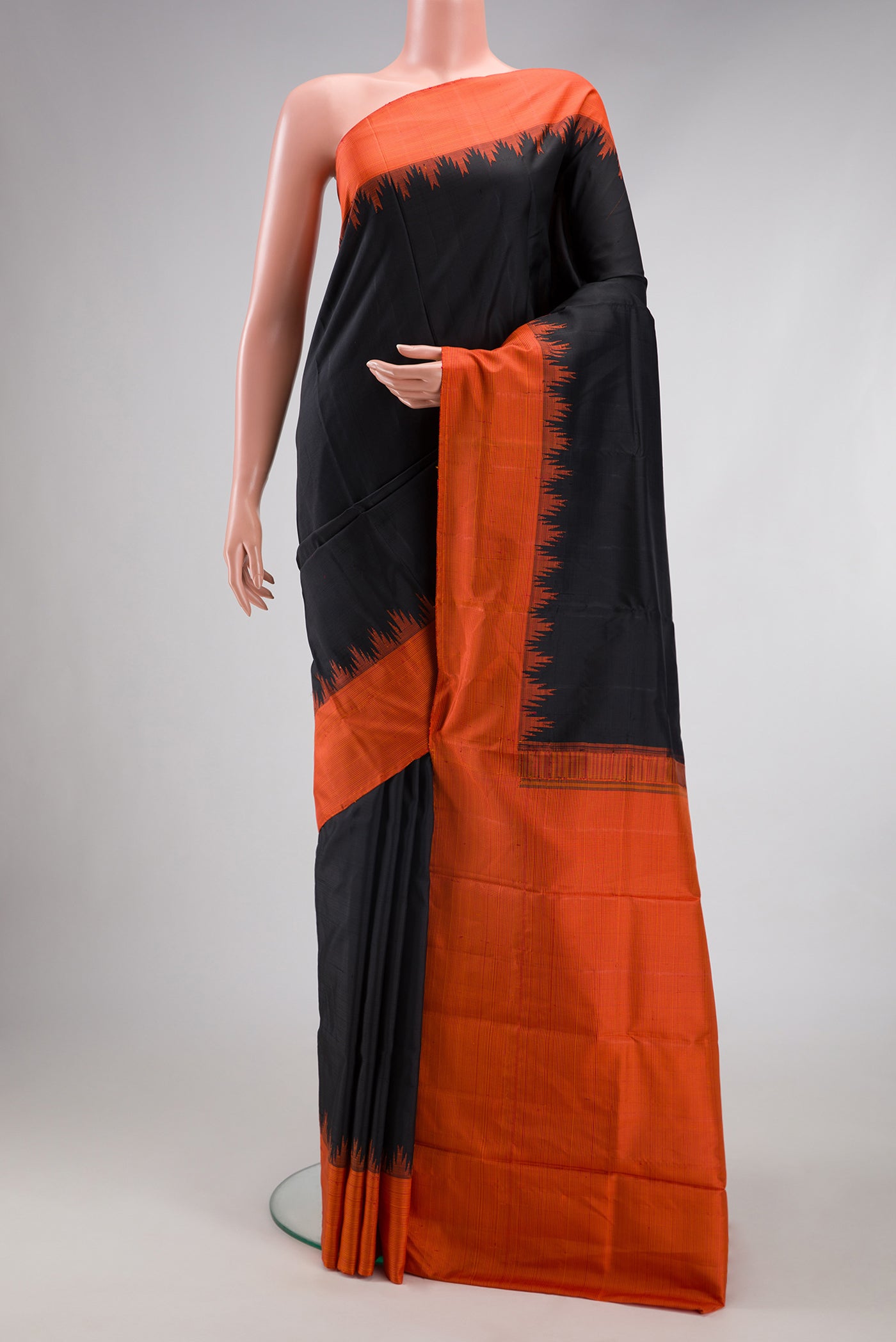 Black Kanjivaram Silk Saree with Plain Body and Temple Border.  displayed on a mannequin