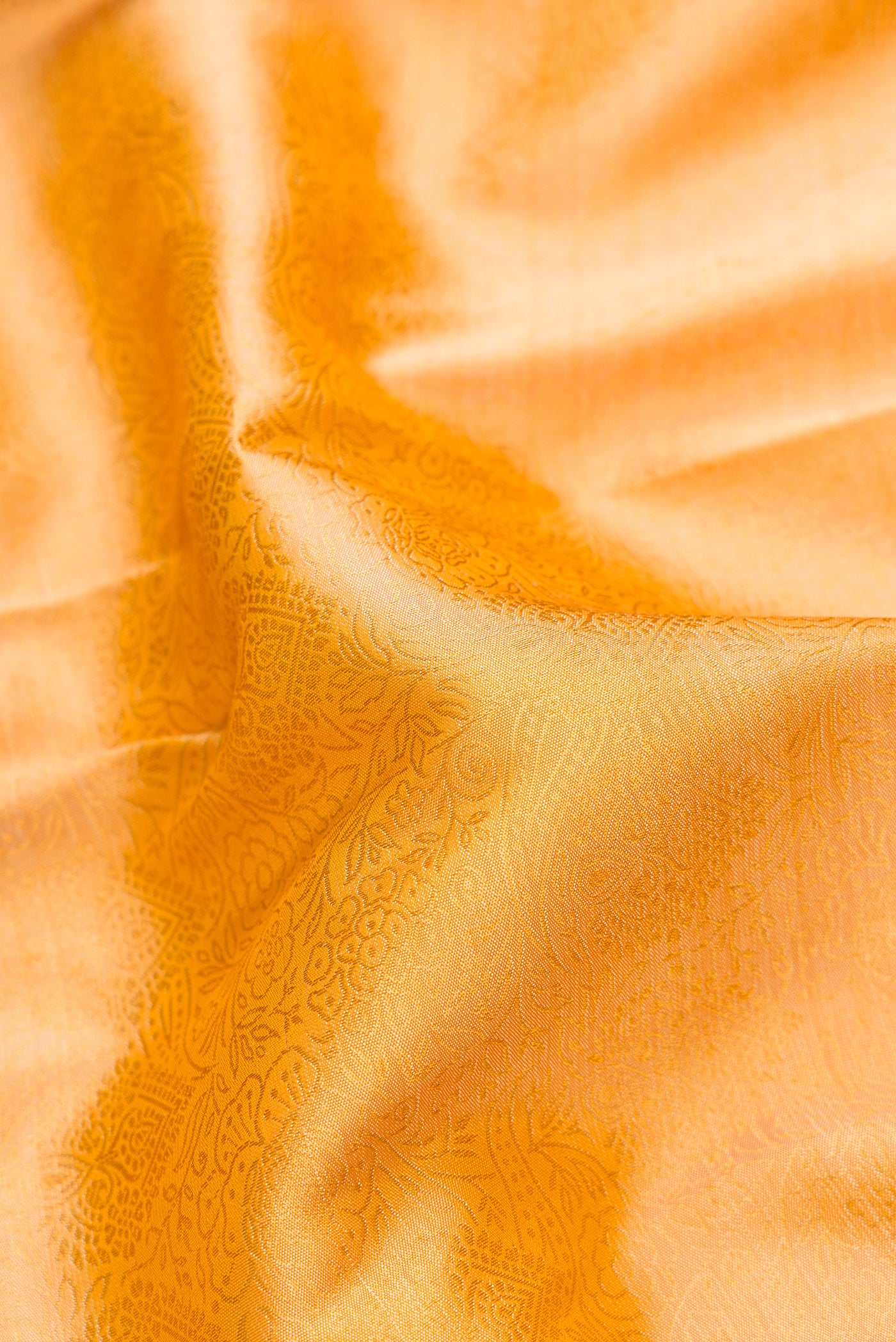 Close up of Sandal Dual Tone Kanjivaram Silk Saree with Zari Brocade on the body and Zari Border.  displaying folds