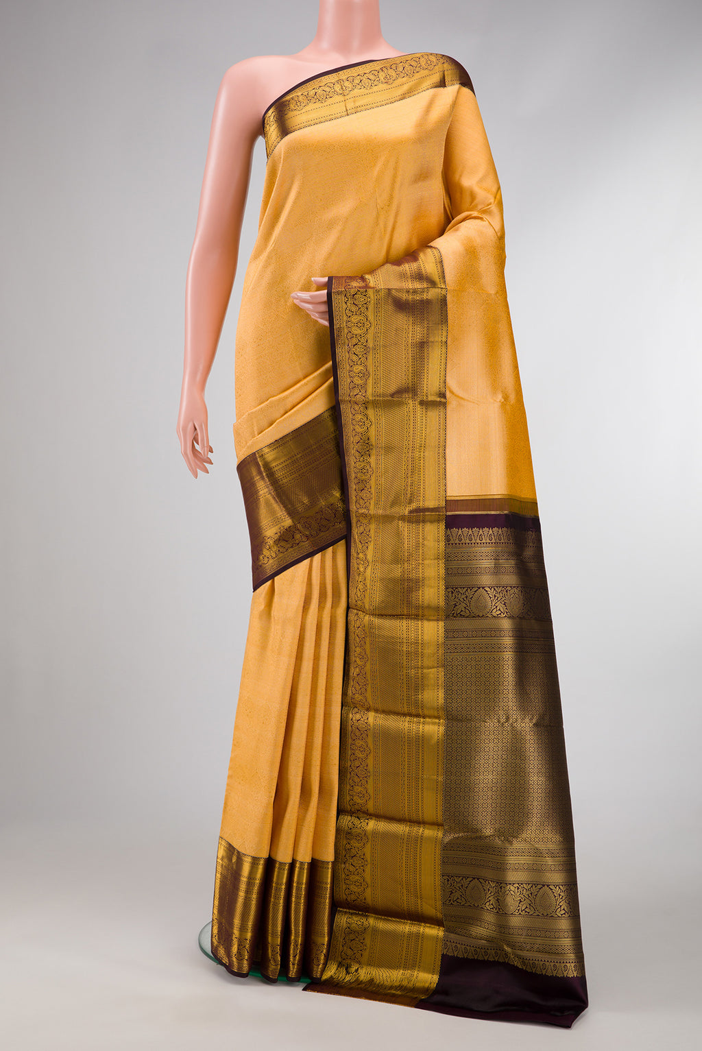 Sandal Dual Tone Kanjivaram Silk Saree with Zari Brocade on the body and Zari Border.  displayed on a mannequin