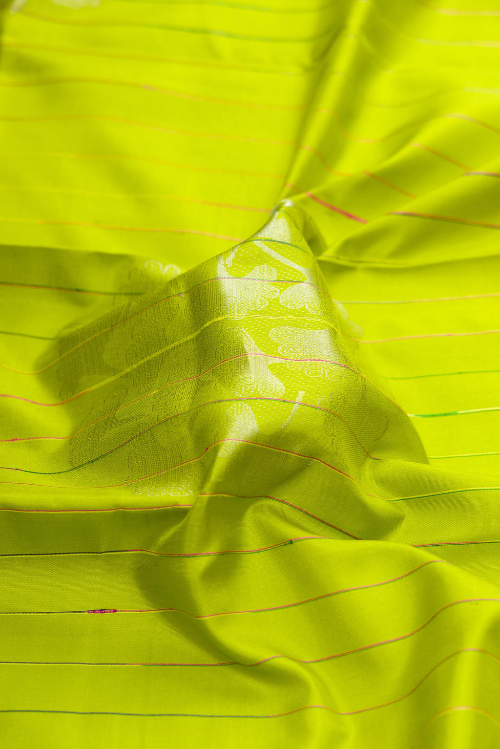 Close up of Parrot Green Dual Tone Kanchipuram Silk Saree with Stripes on the body and Without Border displaying folds