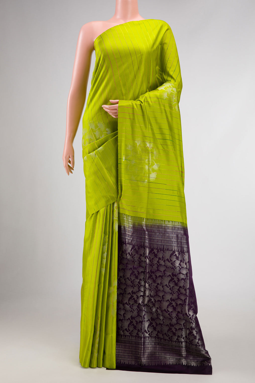 Parrot Green Dual Tone Kanchipuram Silk Saree with Stripes on the body and Without Border displayed on a mannequin