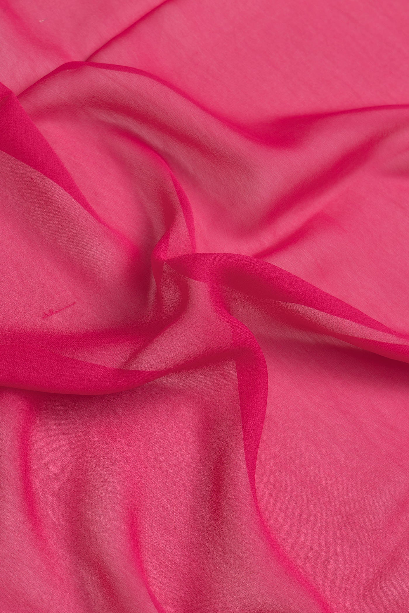 Close up of Dark Pink Dual Tone Georgette Saree with Plain Body and Zari Border.  displaying folds