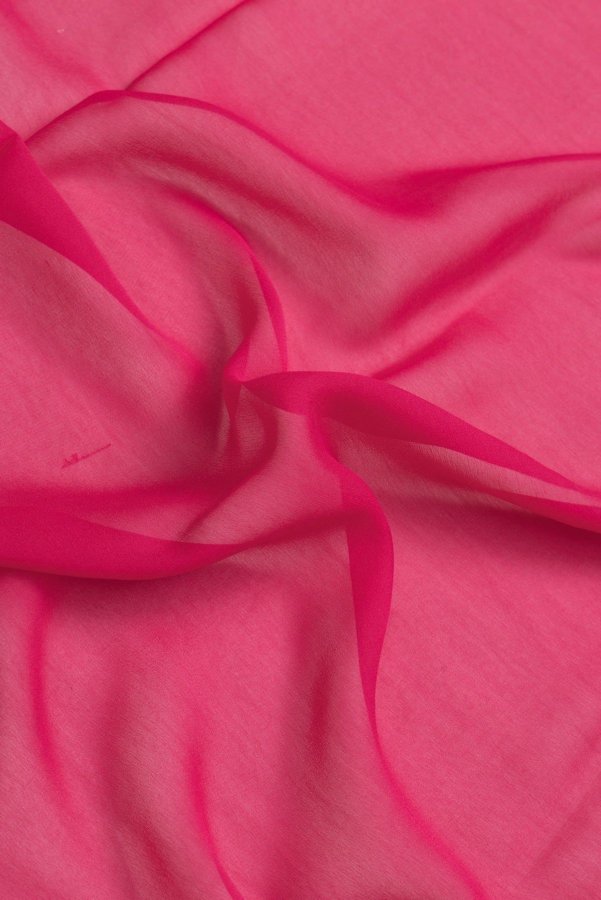 Close up of Dark Pink Dual Tone Georgette Saree with Plain Body and Zari Border.  displaying folds