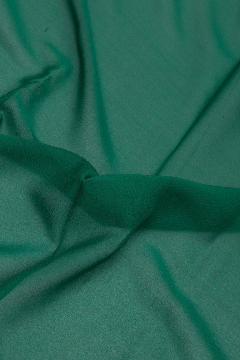 Close up of Green Mysore Georgette Saree with Plain Body and Zari Border.  displaying folds