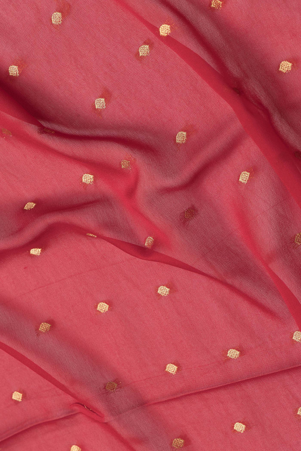 Close up of Red Dual Tone Georgette Saree with Zari Butta on the body and Zari Border.  displaying folds