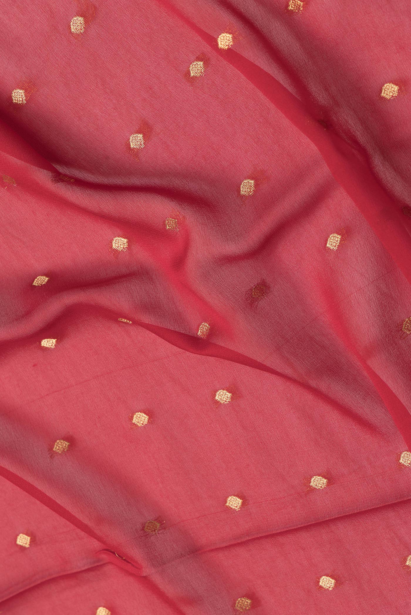 Close up of Red Dual Tone Georgette Saree with Zari Butta on the body and Zari Border.  displaying folds
