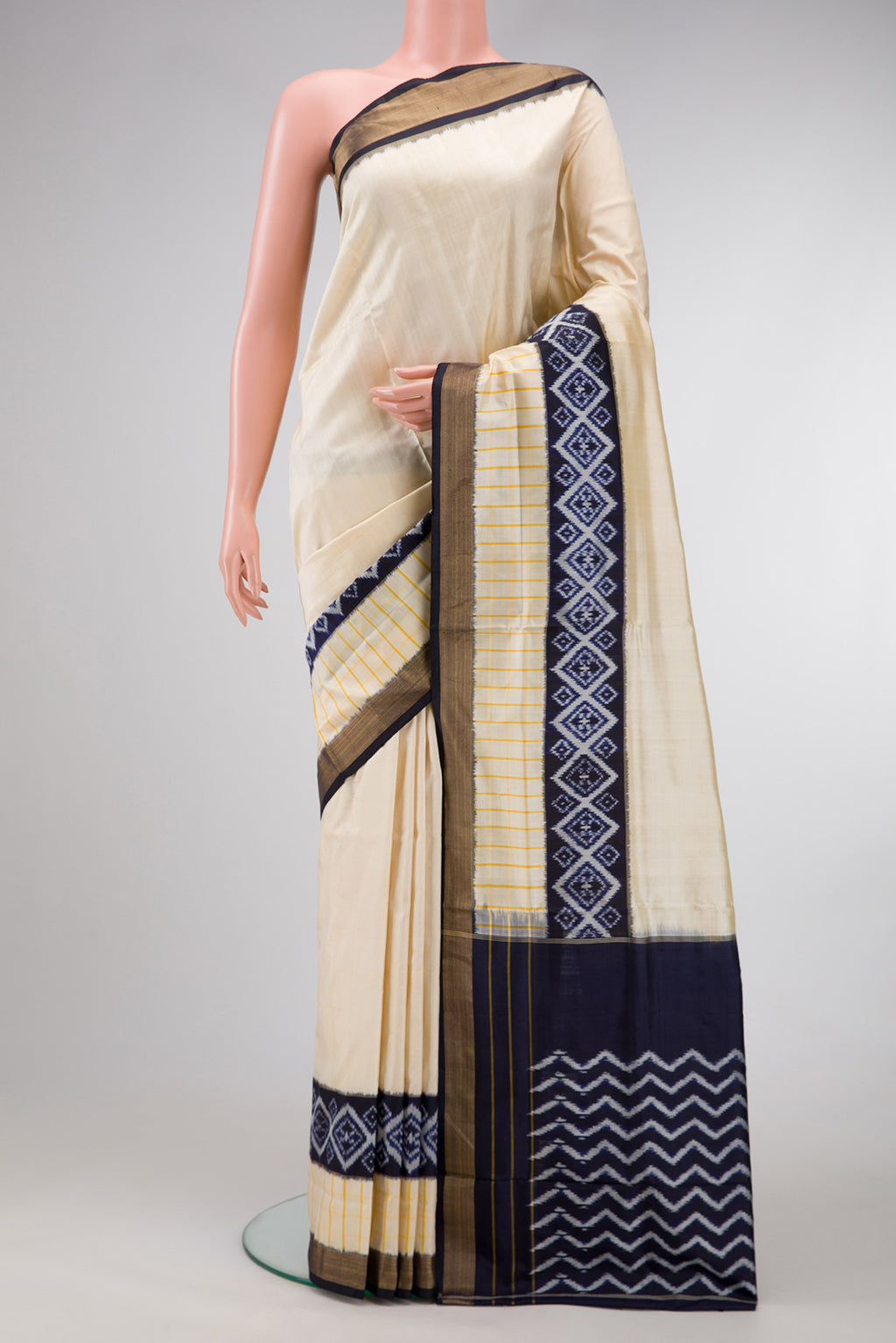 Beige Dual Tone Double Ikat Saree with Plain Body and Ikat Border.  displayed on a mannequin