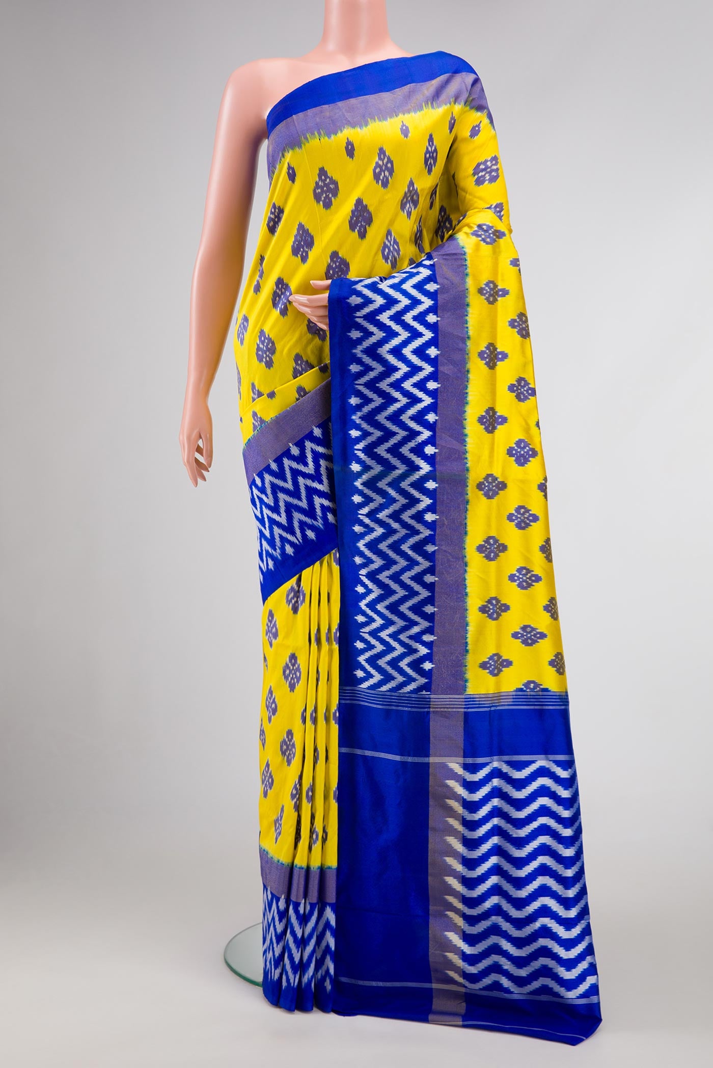 Lemon Yellow Dual Tone Double Ikat Saree with Ikat Print on the body and Ikat Border.  displayed on a mannequin