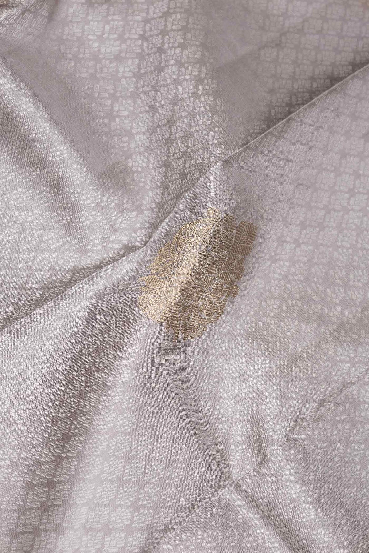 Close up of Grey Dual Tone Kanchipuram Silk Saree with Jacquard With Zari Butta on the body and Zari Border displaying folds