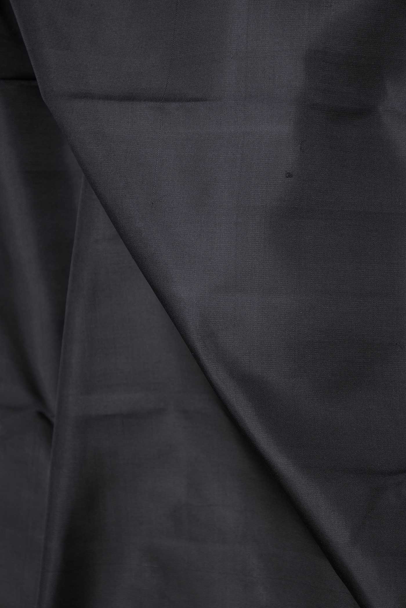 Close up of Pure Silk Pure Zari Black Dual Tone Kanchipuram Saree with Plain Body and Zari Border displaying folds