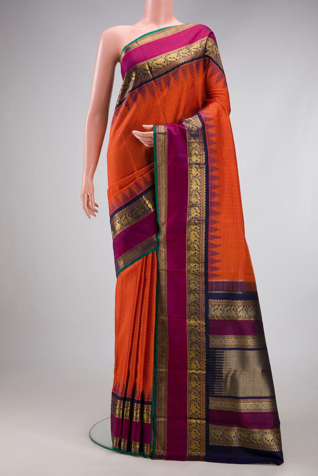 Pure Silk Pure Zari Orange Kanchipuram Saree with Checked design on the body and Temple Border.  displayed on a mannequin