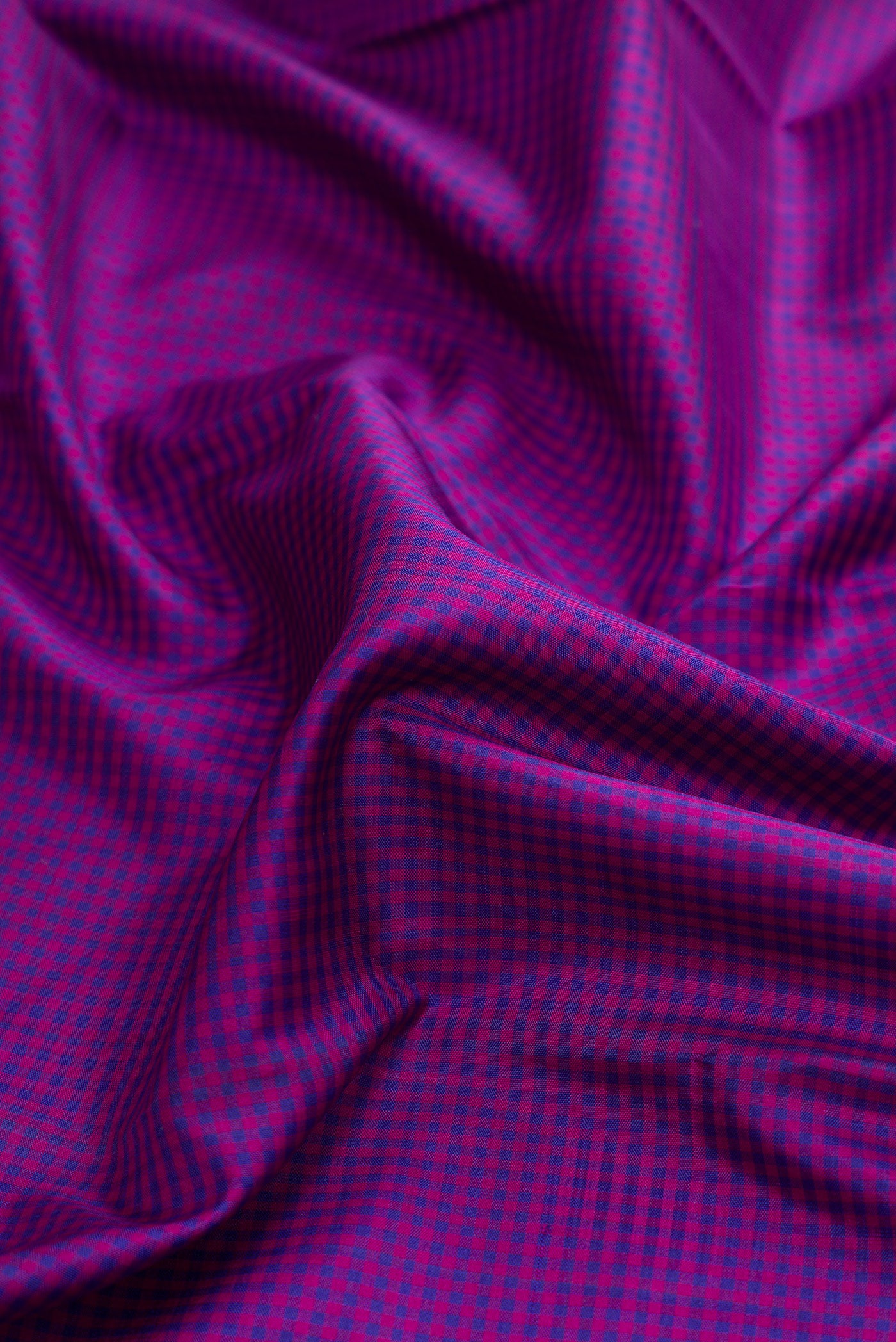 Close up of Pure Silk Pure Zari Purple Dual Tone Kanchipuram Saree with Checked design on the body and Temple Border.  displaying folds