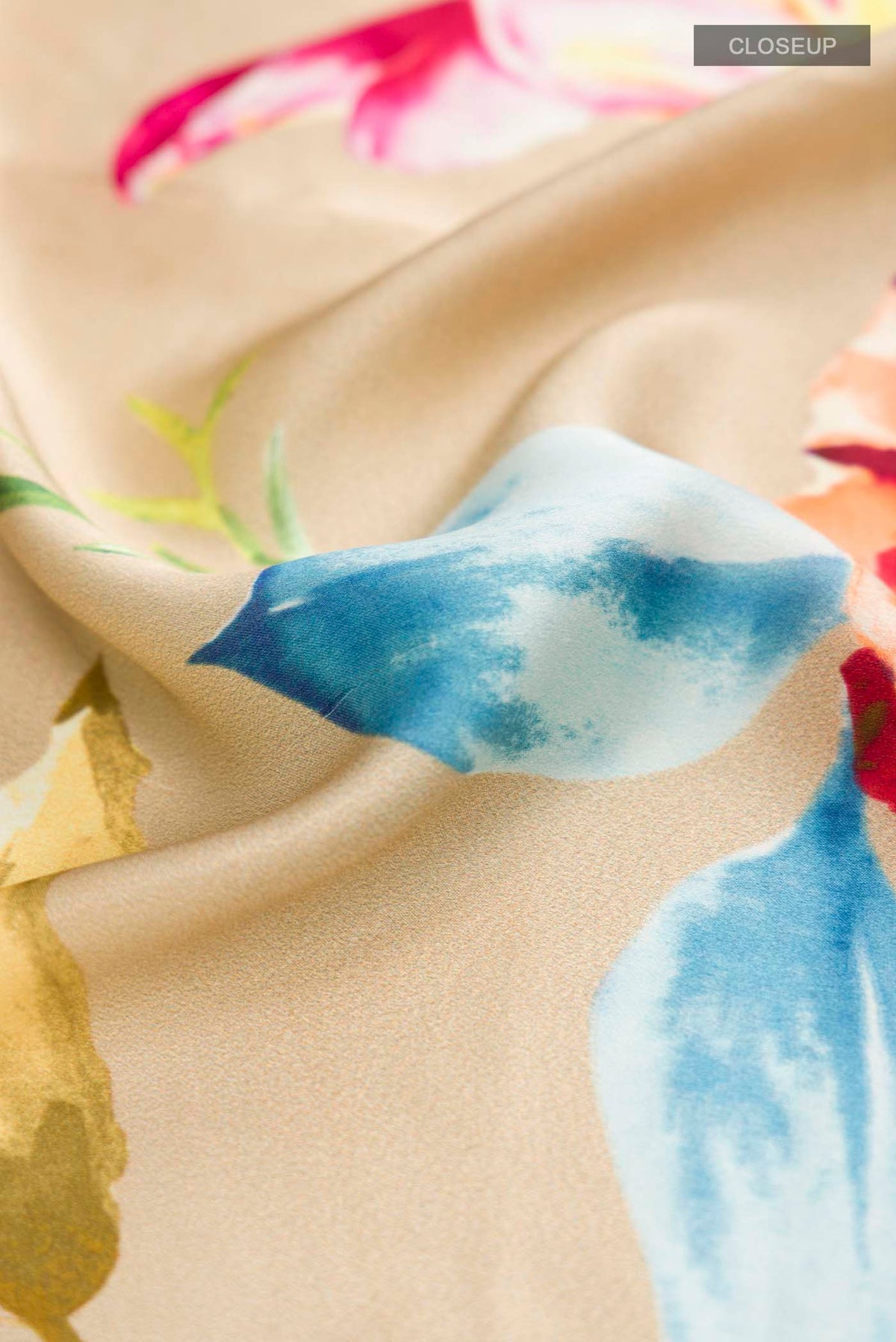 Close up of Beige Satin Silk Saree with Floral Print on the body and Without Border displaying folds