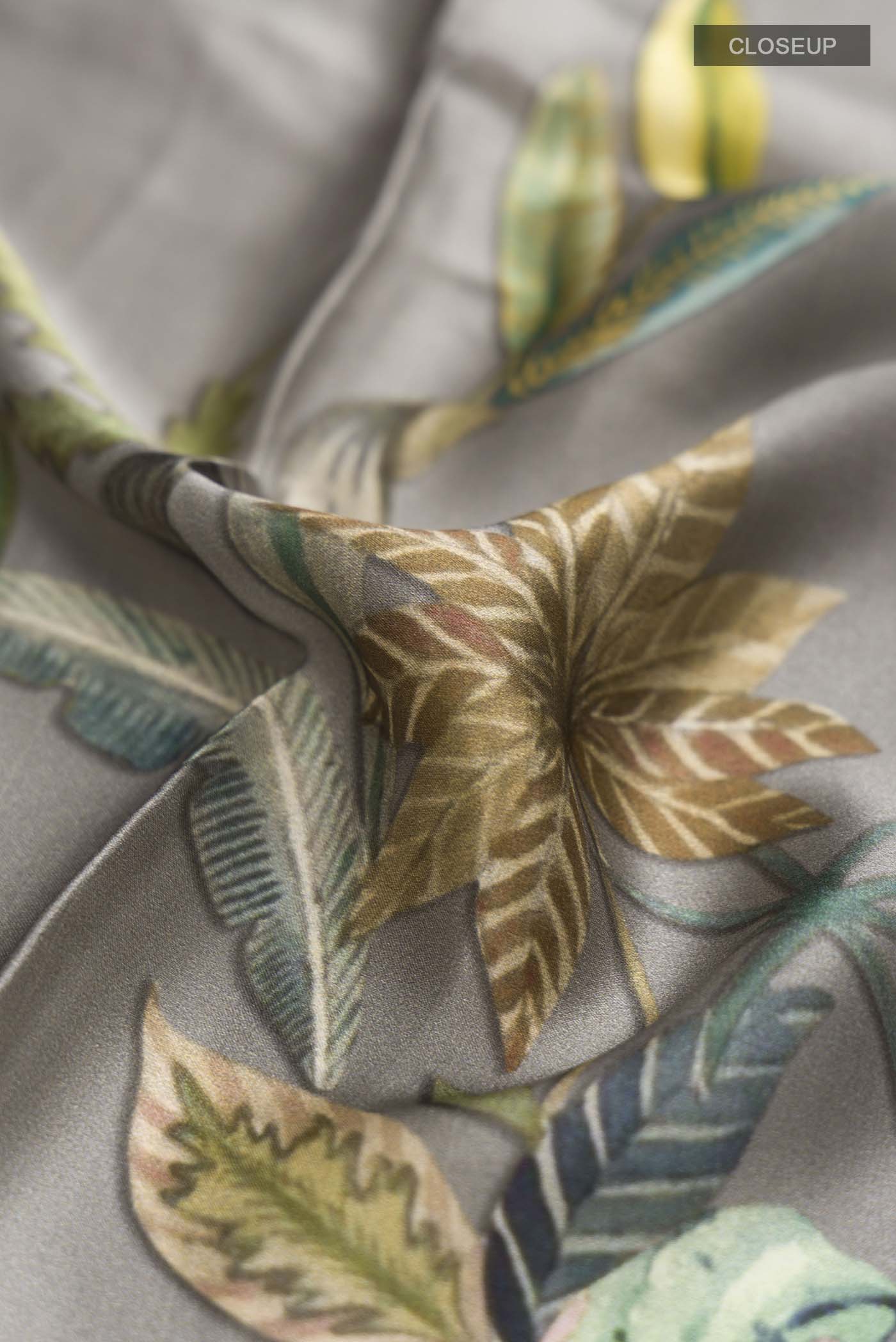 Close up of Grey Satin Silk Saree with Floral Print on the body and Without Border displaying folds