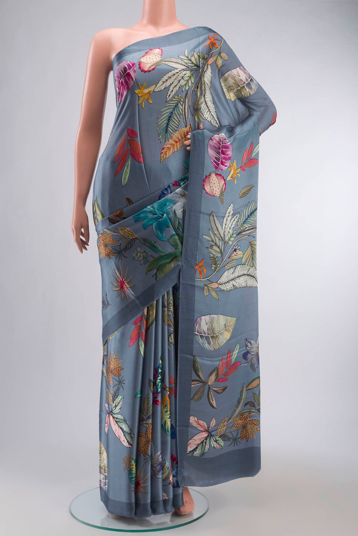 Blue Satin Silk Saree with Printed design on the body and Plain Border displayed on a mannequin