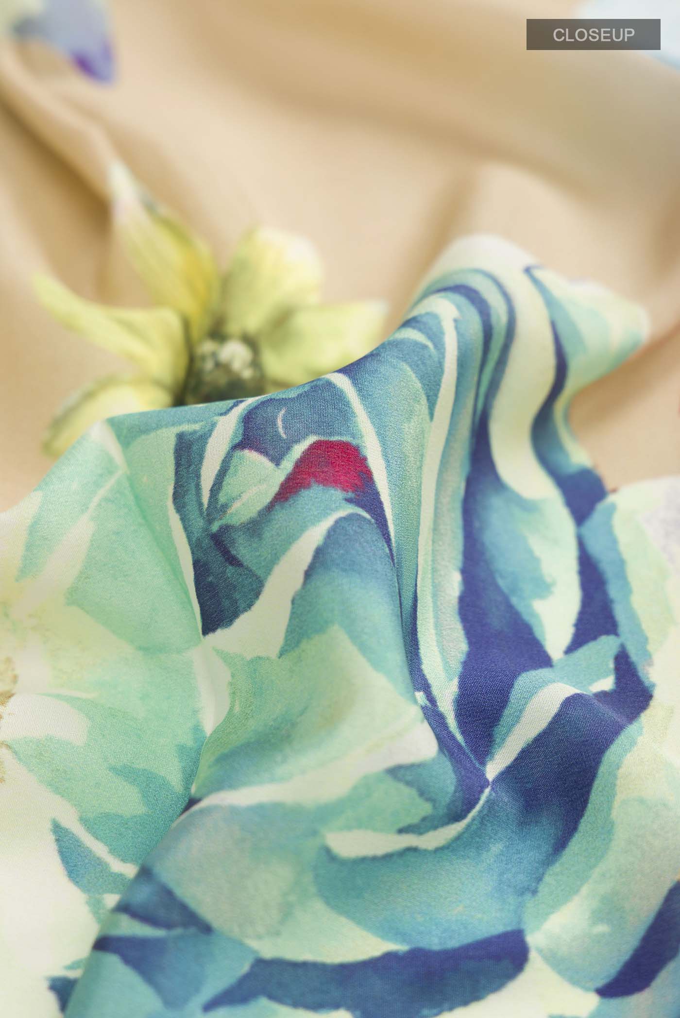 Close up of Beige Mysore Crepe Saree with Printed design on the body and Plain Border displaying folds