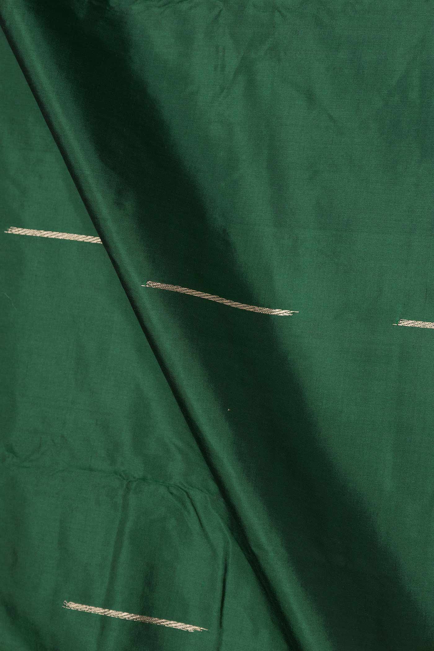 Close up of Green Dual Tone Banarasi Silk Saree with Zari Butta on the body and Zari Border displaying folds