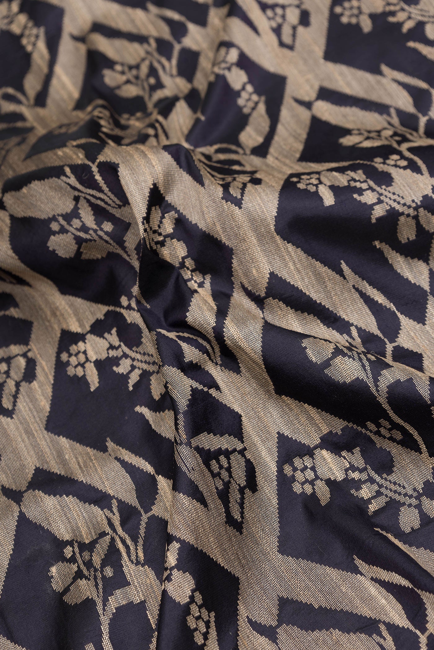 Close up of Navy Blue Dual Tone Tussar Silk Saree with Jacquard design on the body and Plain Border.  displaying folds