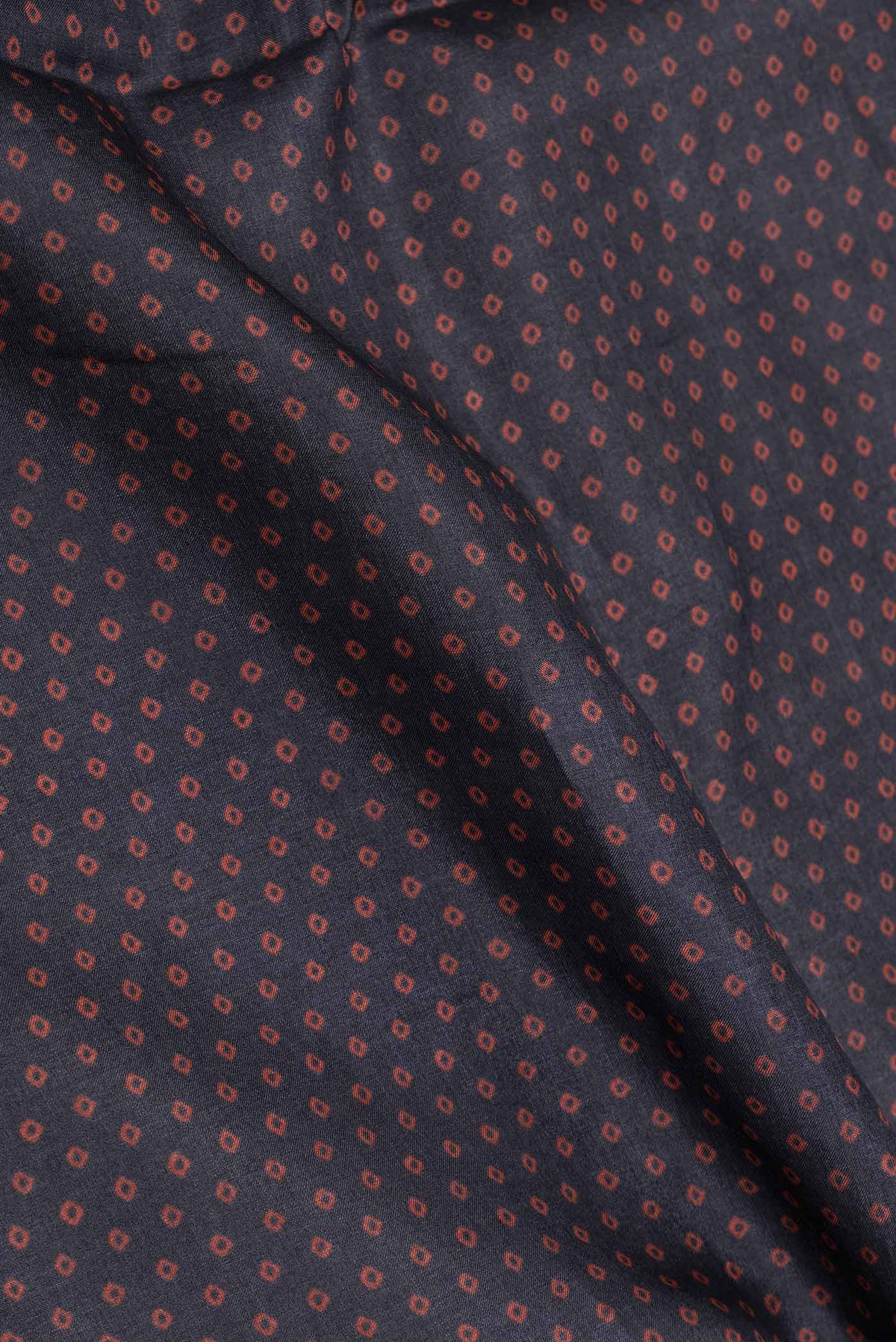 Close up of Black Dual Tone Tussar Saree with Bandhani Print on the body and Printed Border displaying folds