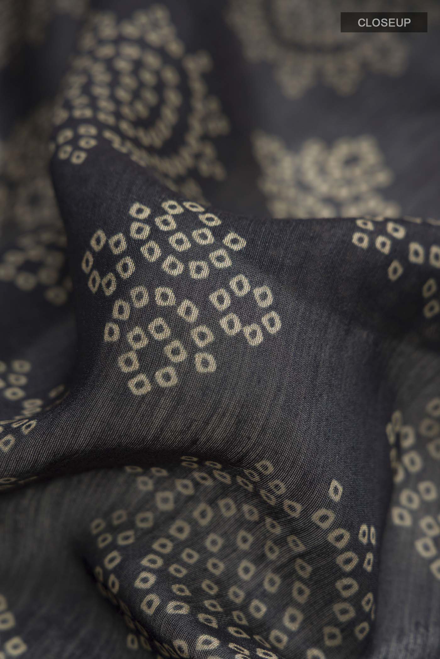Close up of Black Bhagalpuri Tussar Silk Saree with Printed design on the body and Zari Border displaying folds