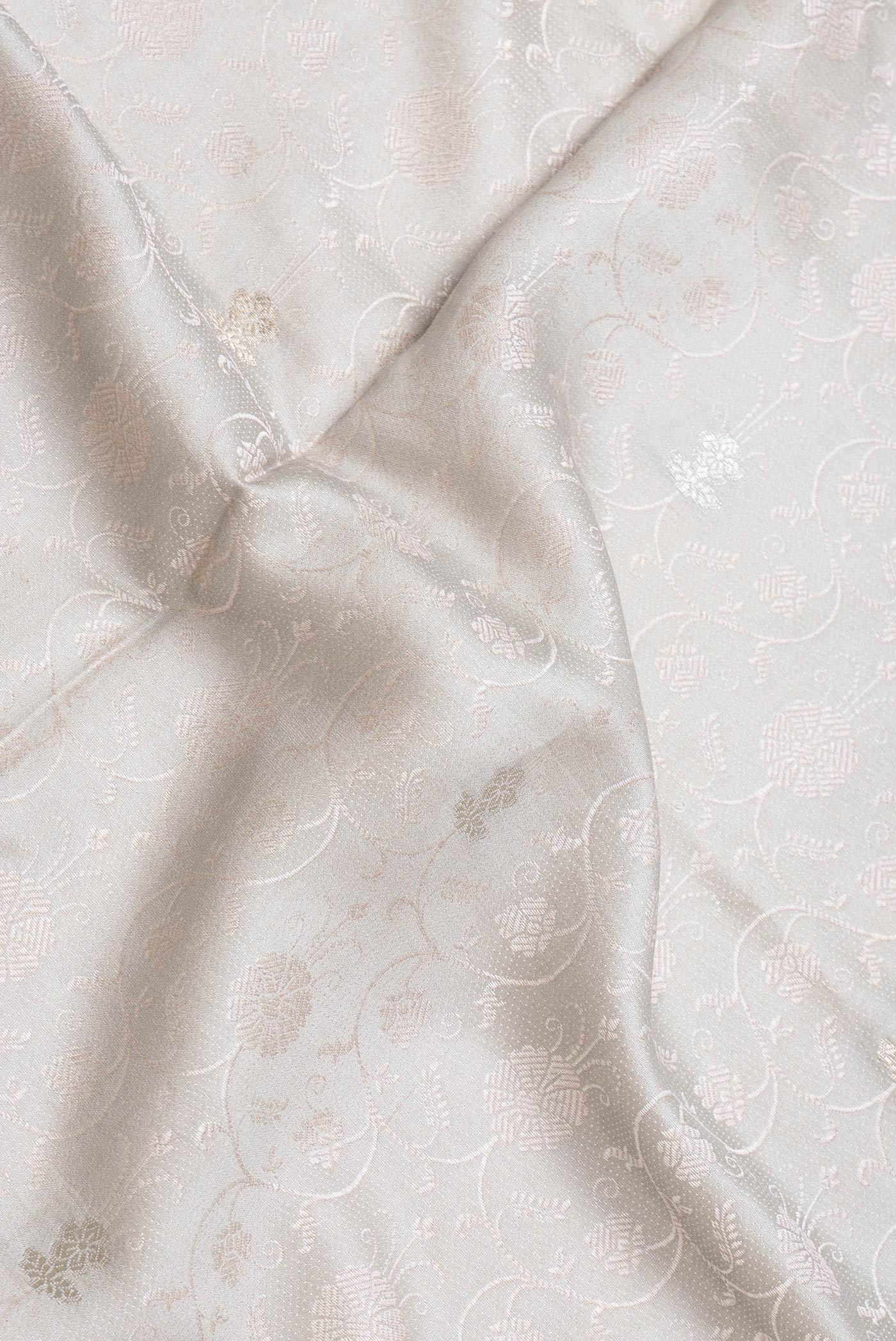 Close up of Grey Dual Tone Tussar Silk Saree with Jacquard design on the body and Thin Zari Line.  displaying folds