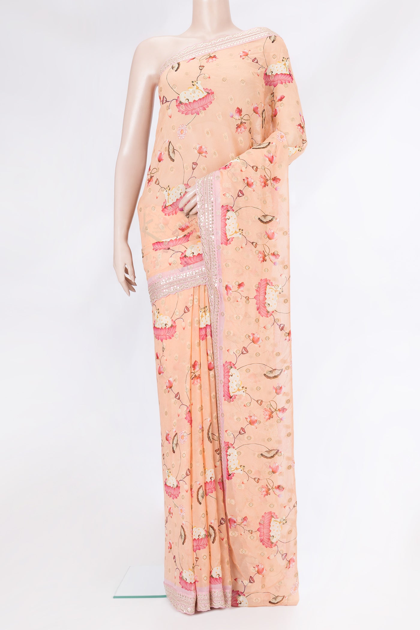 Peach Dual Tone Georgette Saree with Embroidery on the body and Embroidery Border.  displayed on a mannequin