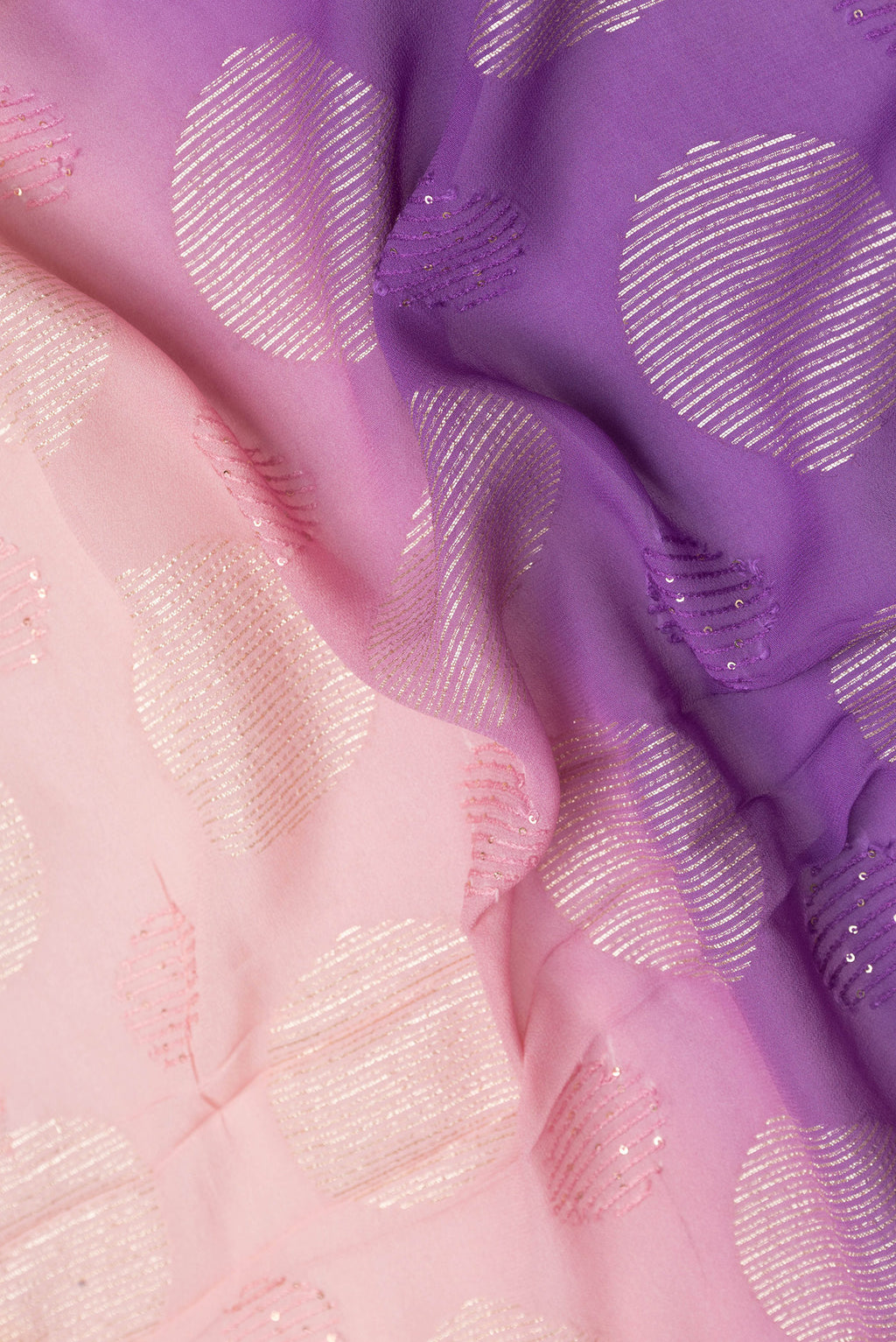Close up of Peach Dual Tone Georgette Saree with Embroidery on the body and Embroidery Border.  displaying folds