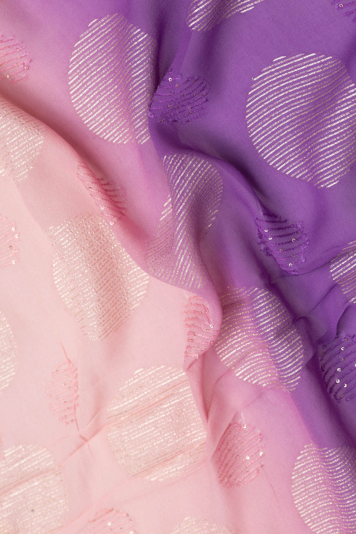 Close up of Peach Dual Tone Georgette Saree with Embroidery on the body and Embroidery Border.  displaying folds
