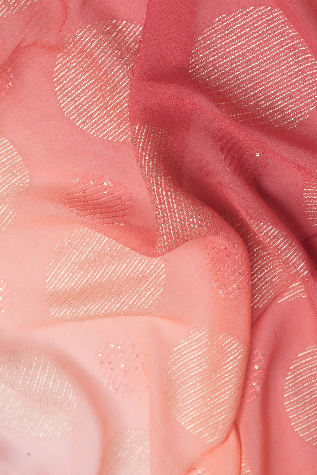 Close up of Golden Peach Dual Tone Georgette Saree with Embroidery on the body and Embroidery Border.  displaying folds