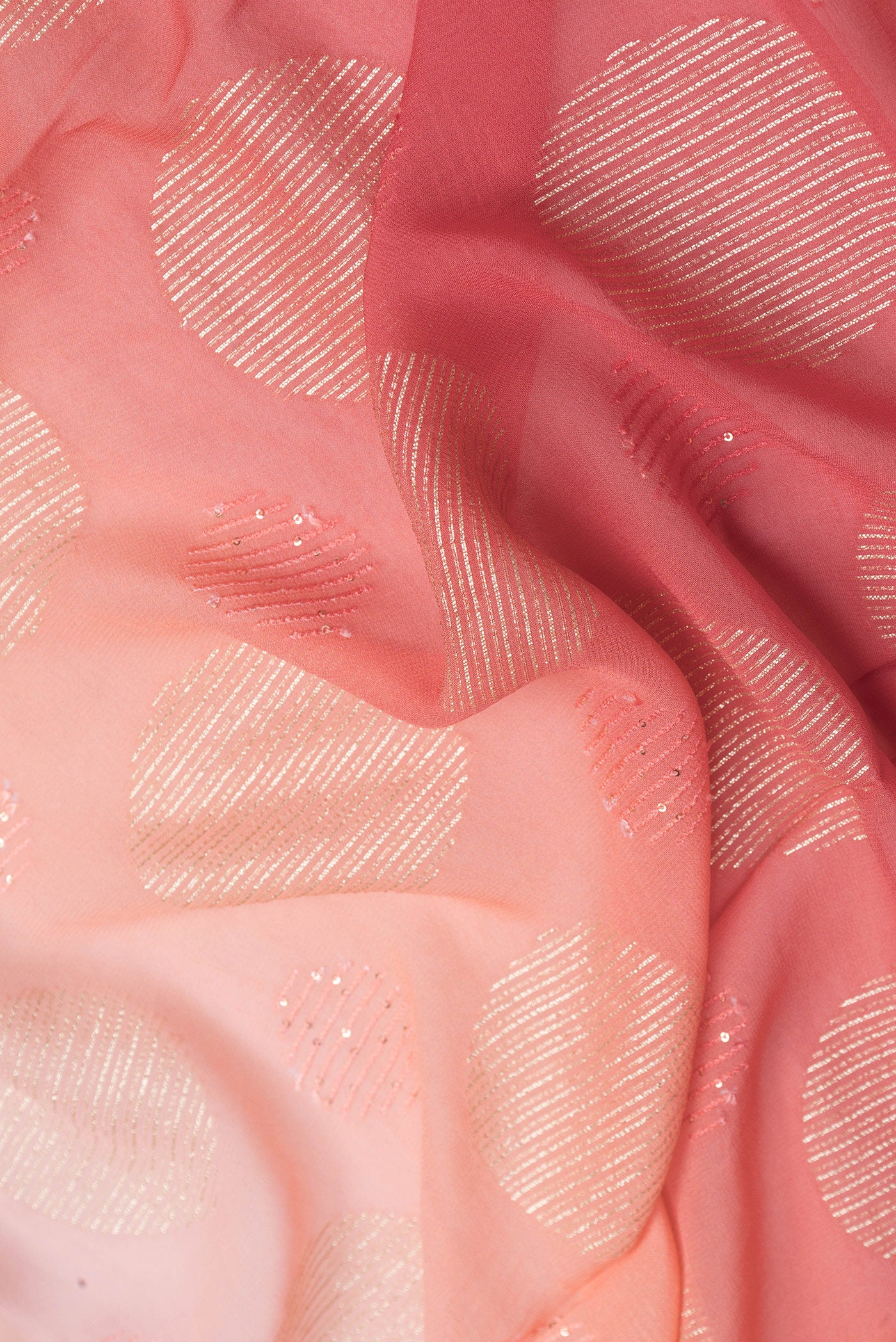 Close up of Golden Peach Dual Tone Georgette Saree with Embroidery on the body and Embroidery Border.  displaying folds