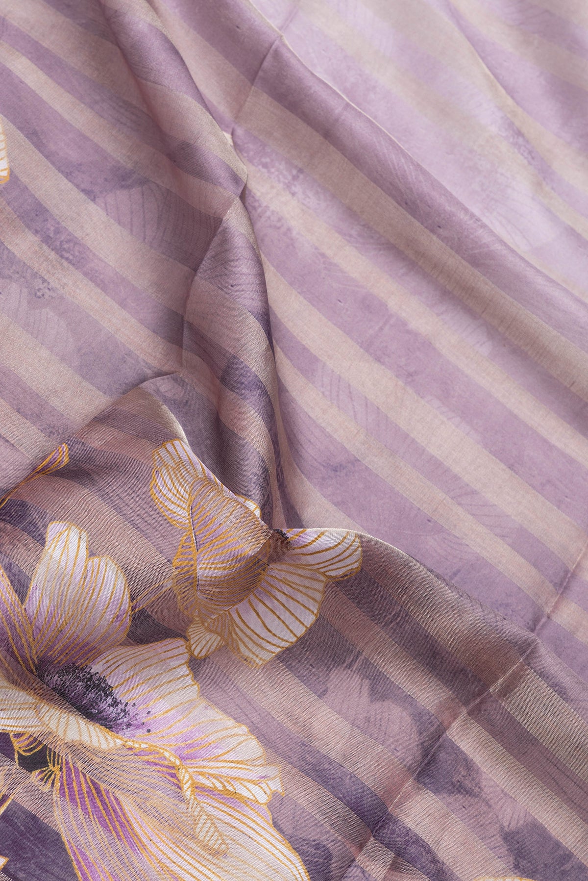 Close up of Lavender Dual Tone Tussar Silk Saree with Printed design on the body and Zari Border.  displaying folds
