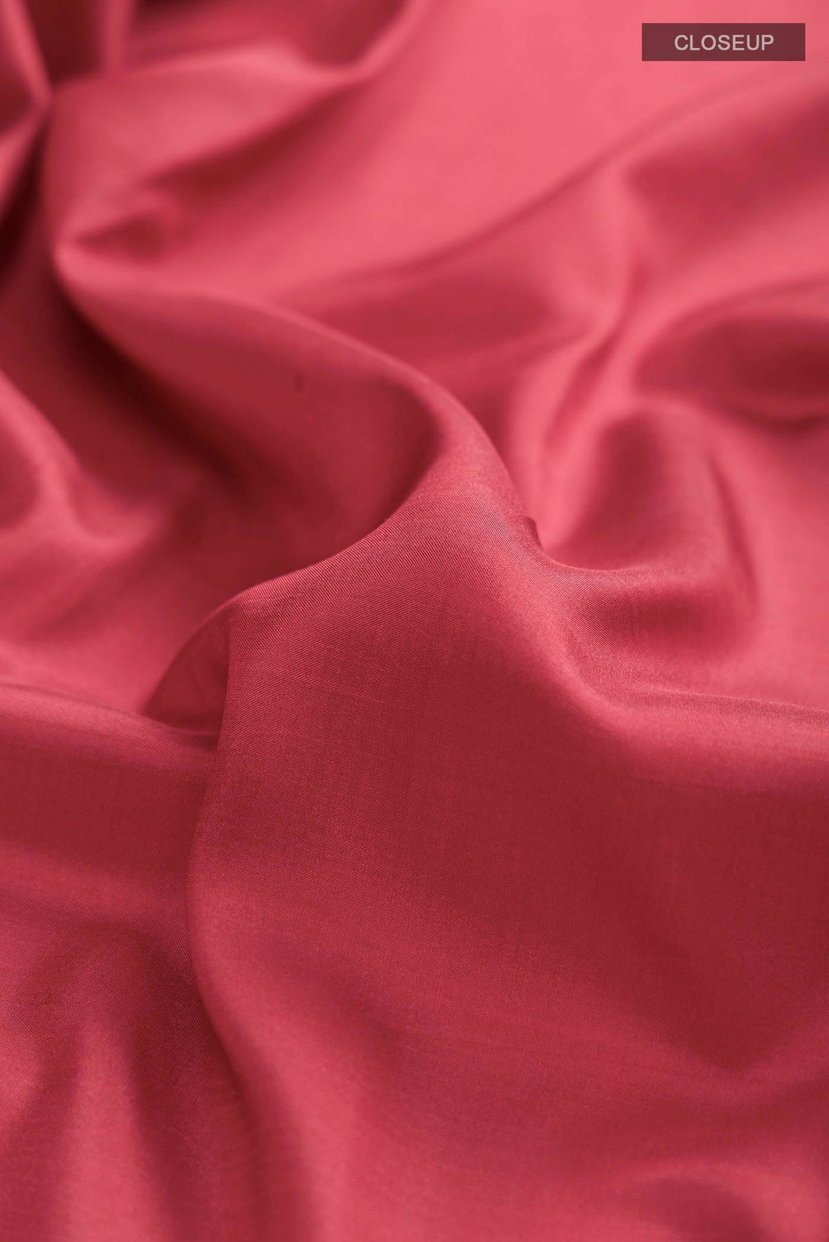 Close up of Red Printed Silk Saree with Plain Body and Zari Border displaying folds