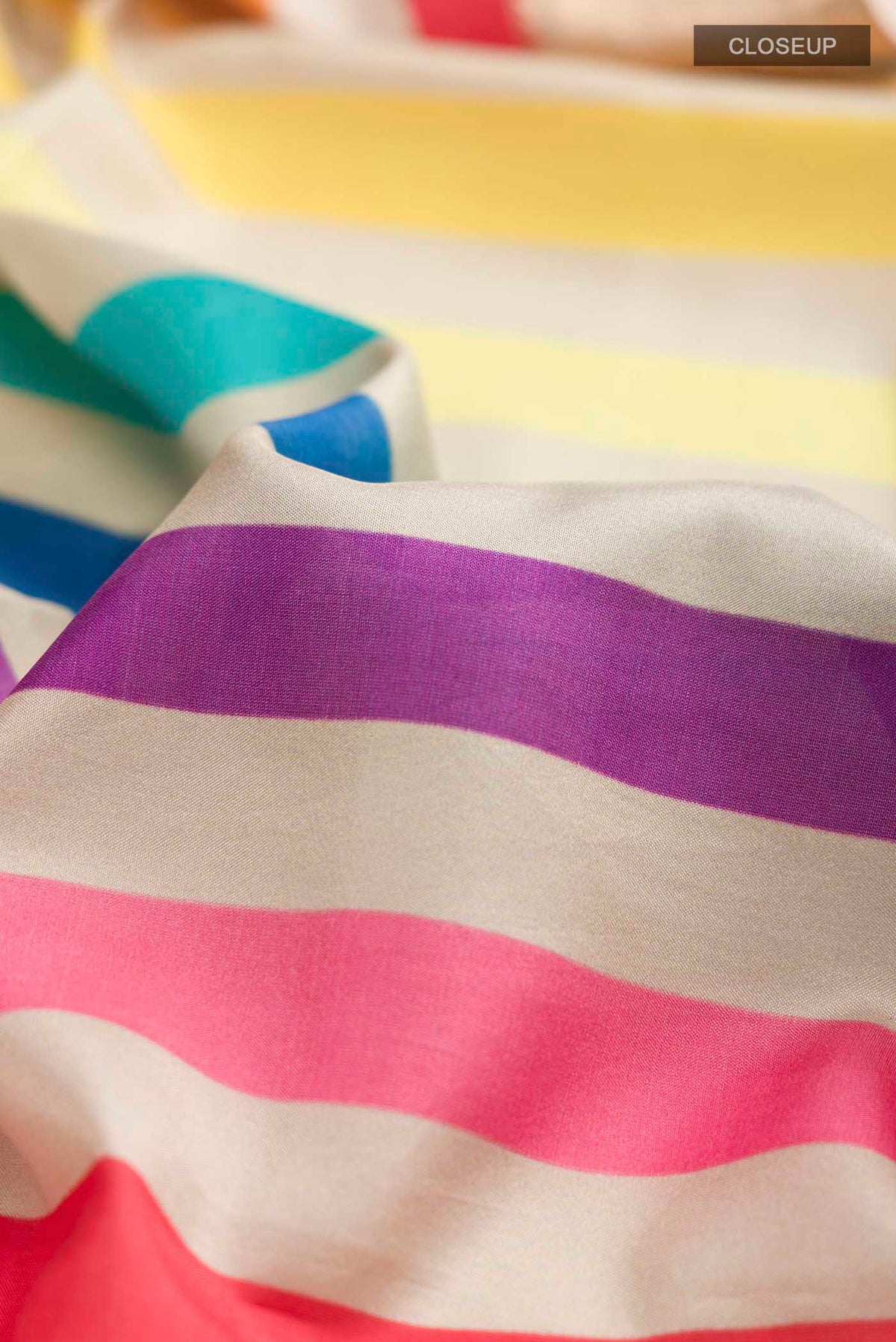 Close up of Multi Color Printed Silk Saree with Printed design on the body and Zari Border displaying folds