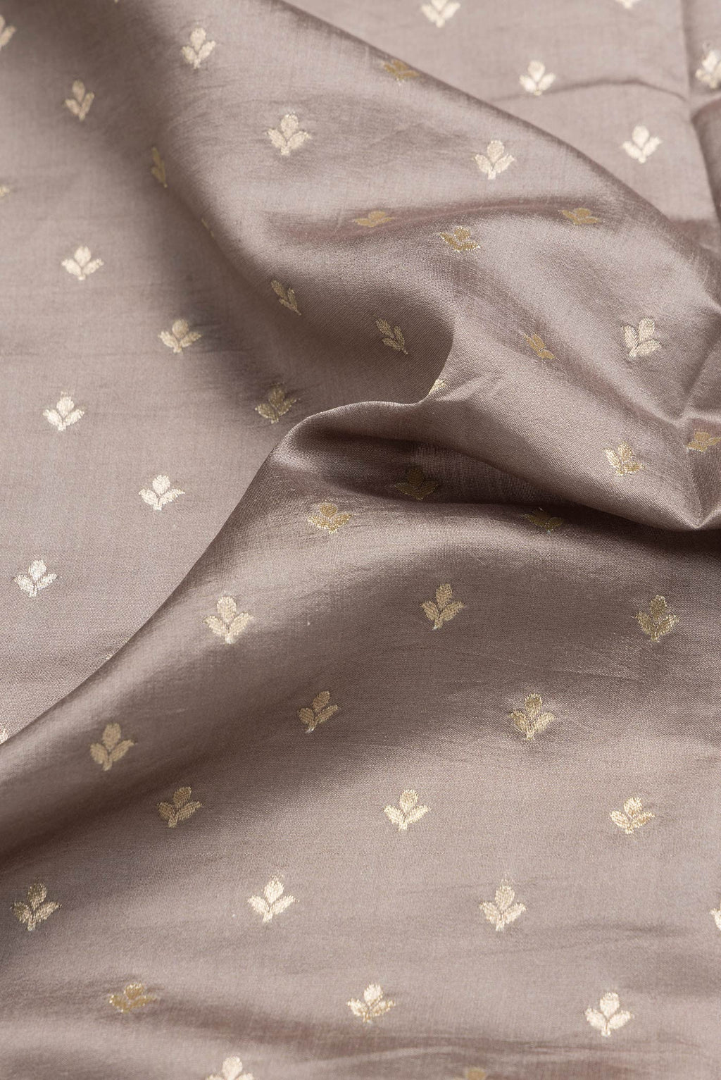 Close up of Grey Dual Tone Tussar Silk Saree with Printed design on the body and Zari Border.  displaying folds